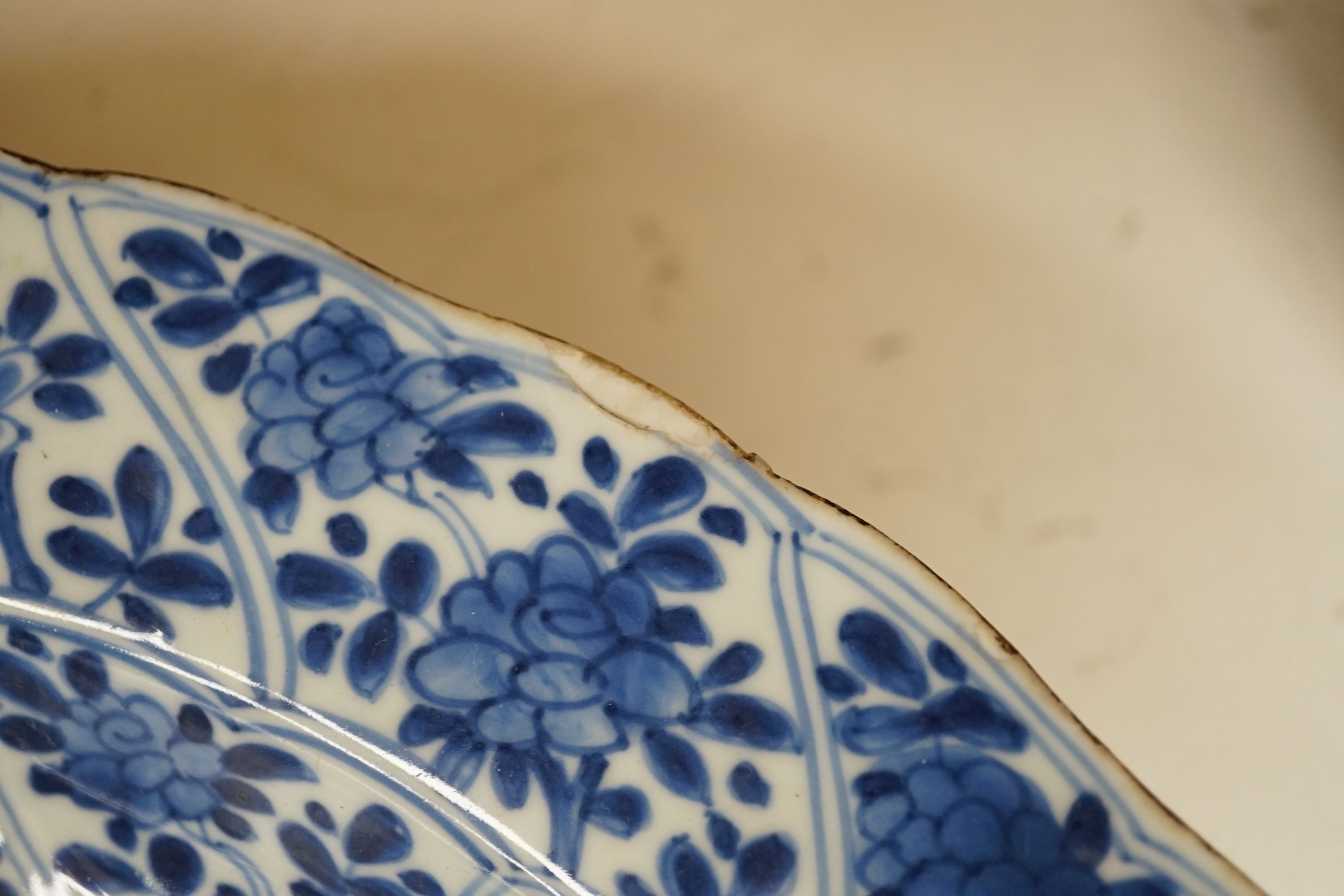 A pair of Chinese Kangxi blue and white dishes, painted with rock work and flowers, artemisia leaf marks, 37cm diameter